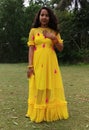 A beautiful Indian girl wering along dress.