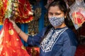 A Beautiful Indian lady wearing face mask is shopping for the Navratri festival in India.