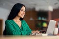 Beautiful indian lady chilling at cafe, using laptop Royalty Free Stock Photo