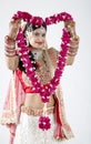 Beautiful Muslim Bride on gray background with Garlands