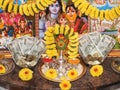 Beautiful Indian Puja Room with rupee notes arranged in a plate, gods photo and kalash decorated with flowers