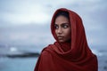 Beautiful indian woman with red paranja and blue eyes in the twilight