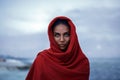 Beautiful indian woman with red paranja and blue eyes in the twilight