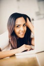 Beautiful Indian woman student using laptop computer at home Royalty Free Stock Photo