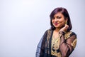 Beautiful Indian woman in traditional sari dress looking at camera bindi on the forehead