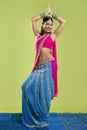 Beautiful indian young brunette woman dancing