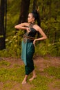 Beautiful Indonesian dancers with traditional green costumes and black tied hair posing inside the forest Royalty Free Stock Photo