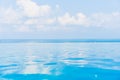 Beautiful infinity outdoor swimming pool with sea ocean view around white cloud blue sky Royalty Free Stock Photo