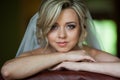 Beautiful innocent blonde bride leaning against chair closeup Royalty Free Stock Photo