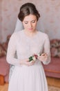 Beautiful innocent bride at home in white wedding dress, preparations concept. Portrait of tender girl in gown Royalty Free Stock Photo