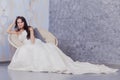 Beautiful innocent brunette bride in white dress posing Royalty Free Stock Photo