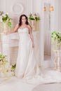 Beautiful innocent brunette bride in white dress posing Royalty Free Stock Photo