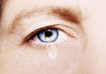 A beautiful insightful look woman`s eye with tear drop. Close up shot Royalty Free Stock Photo