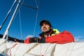 Beautiful inspiring shot of action adventure of sailor or captain on yacht or sailboat attaching big mainsail or