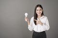 Beautiful intelligent woman is holding light bulb in studio Royalty Free Stock Photo