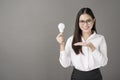 Beautiful intelligent woman is holding light bulb in studio Royalty Free Stock Photo
