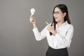 Beautiful intelligent woman is holding light bulb in studio Royalty Free Stock Photo