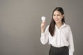 Beautiful intelligent woman is holding light bulb in studio Royalty Free Stock Photo