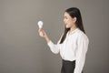 Beautiful intelligent woman is holding light bulb in studio Royalty Free Stock Photo