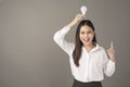 Beautiful intelligent woman is holding light bulb in studio Royalty Free Stock Photo