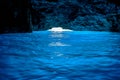 The beautiful inter of the Blue Cave accessed through the tiny entrance in the background on the Greek island of Kastellorizo.