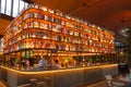 Beautiful interior bar counter covered with illuminated alcohol bottles