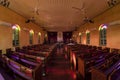 Beautiful interior view of little country church with empty wooden pews Royalty Free Stock Photo