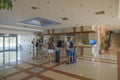 Beautiful interior view of tourists att reception of modern hotel. Rhodes. Greece.