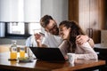 Beautiful interracial couple using laptop computer at home surfing the internet having good time Royalty Free Stock Photo