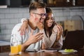 Beautiful interracial couple using laptop computer at home surfing the internet having good time Royalty Free Stock Photo