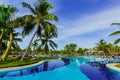 beautiful inviting of stylish swimming pool in tropical garden on sunny gorgeous day