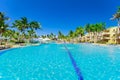 beautiful inviting view of hotel grounds and people relaxing in swimming pool