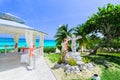 beautiful inviting view of a young girl, lady decorating, preparing beach gazebo for a wedding ceremony tranquil ocean, blue sky