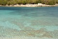 Beautiful Ionian Sea and clear turquoise water at Ksamil Islands with wooden pier after summer season in October Royalty Free Stock Photo