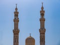 Mosque in the urban area. Dome and towers against a bright blue sky. Royalty Free Stock Photo