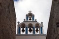 Beautiful island of Santorini, Greece. White Church with a bell tower and old bells in the city of Oia on the island of Santorini Royalty Free Stock Photo