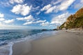 Beautiful Italian beach Michelino in Calabria, Italy - Beach sand at Mediterranean sea and blue sky with soft white clouds Royalty Free Stock Photo