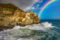 Beautiful italian Coast Cinque Terre Manarola with rainbow sunny and cloudy sky