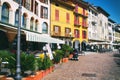 Beautiful Italian park with yellow houses. Cafes near the coast of Pisogne, Italy