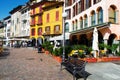 Beautiful Italian park with yellow houses. Cafes near the coast of Pisogne, Italy