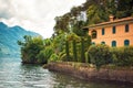 Beautiful italian villa with garden in Bellagio on bank of Como lake, Lombardy, Italy. Amazing view on blue lake and Alps Royalty Free Stock Photo