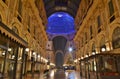 Beautiful inside panoramic view to the Vittorio Emanuele II Gallery with giant blue crest made of Swarovski crystals and cafes.
