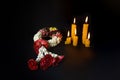 A beautiful jasmine garland with burning candles on a dark background