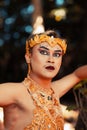 Beautiful Javanese man wearing makeup on his face in a golden crown and golden necklace