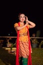 Beautiful Javanese woman with a golden necklace on her neck and golden belt on a yellow dress on their body