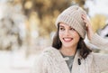 Beautiful joyful woman autumn portrait. Smiling student girl wearing warm clothes and hat in a city in winter Royalty Free Stock Photo