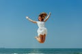 Beautiful Joyfull Girl Jumping on The Beach. Vacation and Relaxing