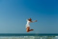 Beautiful Joyfull Girl Jumping on The Beach. Vacation and Relaxing