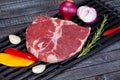 beautiful and juicy raw steak on the table with ingredients ready to roast