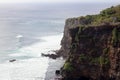 Beautiful jungle beach cliff with blue ocean at Bali Indonesia with yellow sand and green forest in the back. Royalty Free Stock Photo